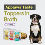 Load image into Gallery viewer, Dog with 'Applaws Taste Toppers in Broth' packaging and text on a light gray background