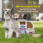 Load image into Gallery viewer, Dog sitting on grass with Hill's Prescription Diet ID pet food containers.