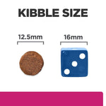 Load image into Gallery viewer, Comparison of kibble size with a 12.5mm diameter round object and a 16mm blue die.