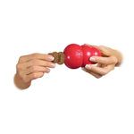Load image into Gallery viewer, Red KONG dog toy held by a person on a white background