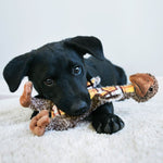 Load image into Gallery viewer, Black puppy playing with a chew toy on a white surface