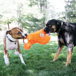 Load image into Gallery viewer, Two dogs playing with an orange plush toy outdoors on a grassy area with trees in the background.