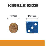 Load image into Gallery viewer, Comparison of kibble size with a brown round kibble and a blue dice showing measurements.