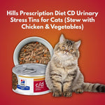 Load image into Gallery viewer, Hills Prescription Diet CD Urinary Stress Tins for Cats with a cat sitting next to them on a red background