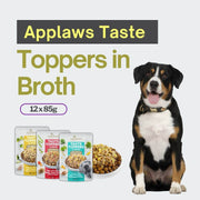 Dog with 'Applaws Taste Toppers in Broth' packaging and text on a light gray background
