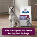 Load image into Gallery viewer, Dog sitting next to a bag of Hill&#39;s Prescription Diet ID Low Fat Dry Food for Dogs on a wooden floor.
