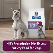 Dog sitting next to a bag of Hill's Prescription Diet ID Low Fat Dry Food for Dogs on a wooden floor.