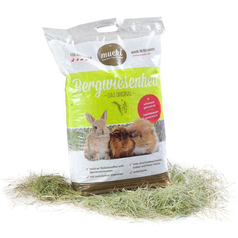 Bag of mucki Bergwiesenheu hay for small animals on a white background