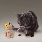 Load image into Gallery viewer, Gray cat playing with a toy llama on a neutral background
