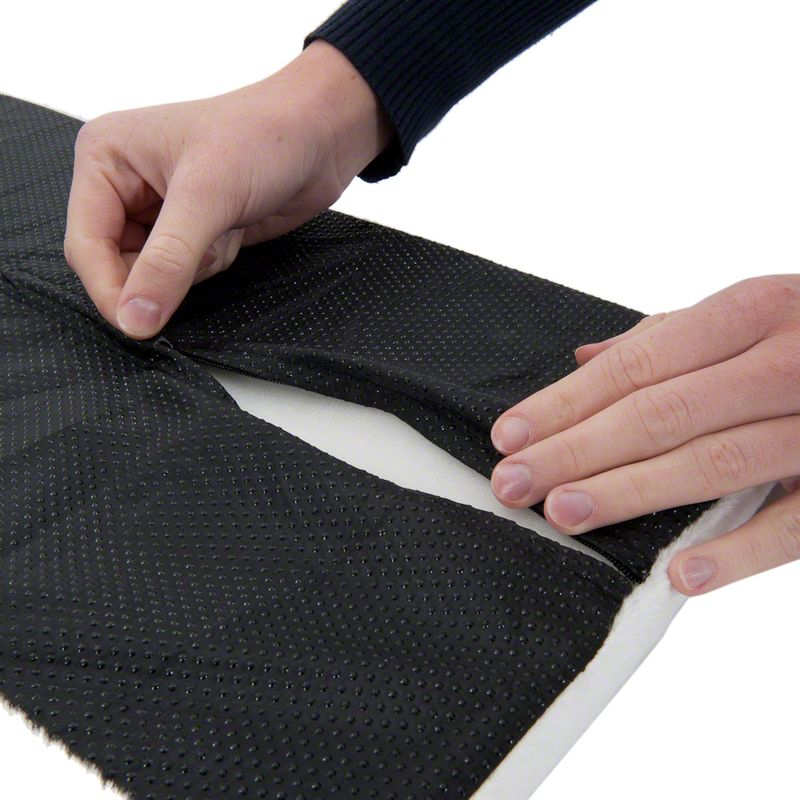Person adjusting a black mesh fabric on a white background