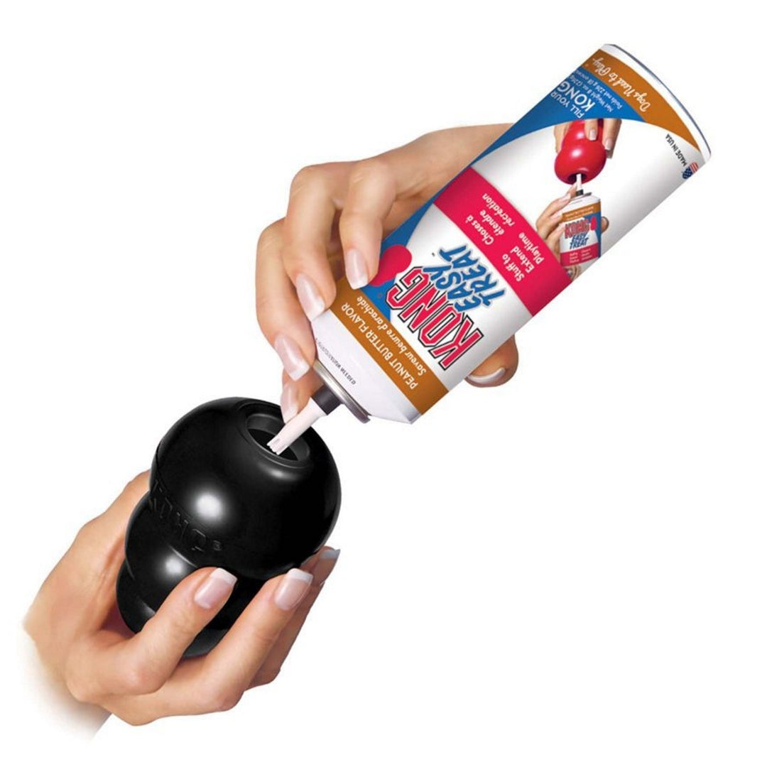 Hand applying a tube of Shoujia paint thinner to a black object on a white background