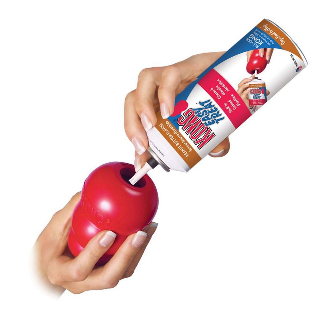 Red apple-shaped toy with a tube of Shur Glue being applied to it, on a white background.