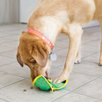 Load image into Gallery viewer, Dog playing with a green and yellow toy on a tiled floor

