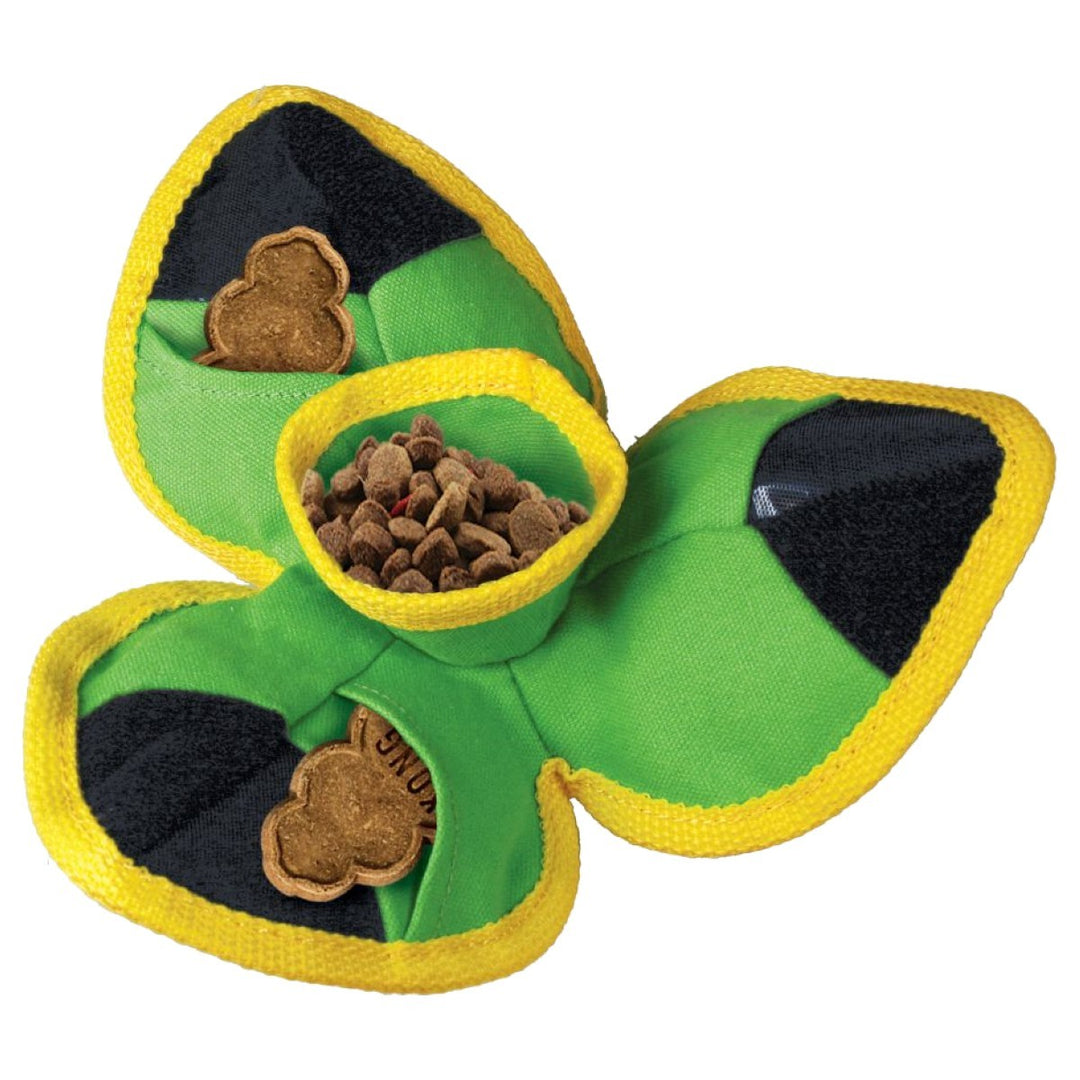 Green shamrock-shaped pet toy with a yellow rim and black interior, filled with treats on a white background.