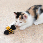 Load image into Gallery viewer, Calico kitten playing with a bee-shaped toy on a carpeted floor
