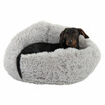 Load image into Gallery viewer, Dog lying in a fluffy gray pet bed on a white background
