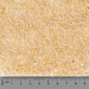 Close-up of beige textured material with a ruler at the bottom
