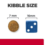 Load image into Gallery viewer, Comparison of kibble size to a blue die showing 7 mm and 16 mm measurements.
