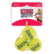 Kong Squeakair tennis balls in a mesh bag with packaging featuring a child and dog illustration.