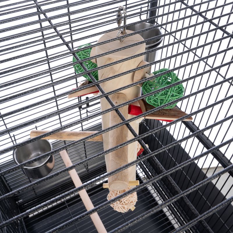 Bird cage with perches, toys, and a water dish inside
